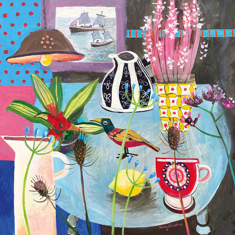 Art greeting card by Jenny Wheatley. Still life with flowers and ornaments on a table with a wooden bird. Sailing boats on the sea out of the window.