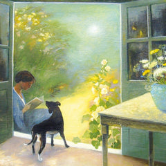 Art greeting card by Lesley McLaren. A woman sitting in a doorway, reading a book with a black dog beside her. Garden with flowers in the background.