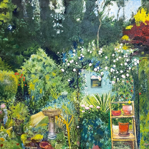 Art greeting card by Marion Eastwood. Oil painting of a cottage garden with flowers, shrubs, a bird bath, pots and a shed. Trees in background.