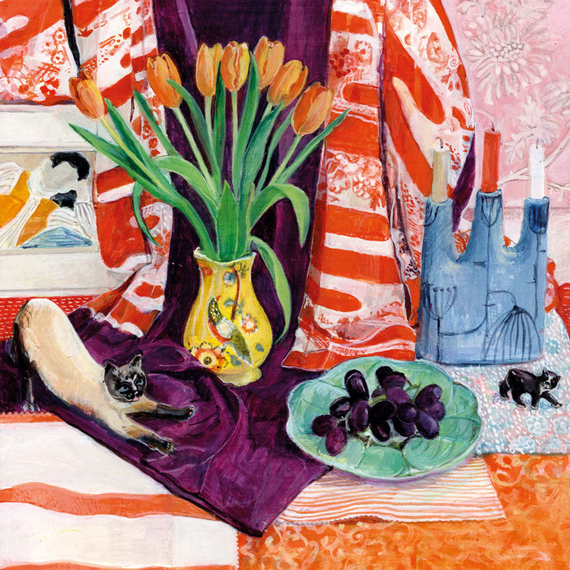 Art greeting card by Rebecca Guyver RBA. Yellow vase of red tulips on a table with knick knacks and scarves and a cat ornamant in 'down dog' pose.