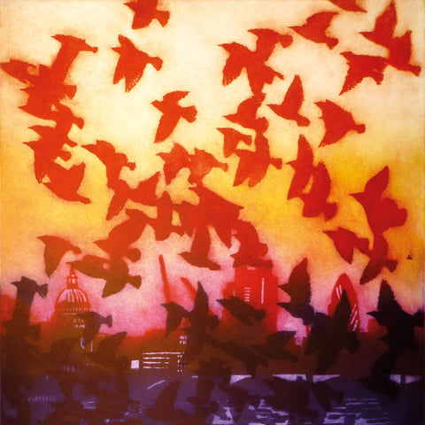 Art greeting card by Susie Perring. A flock of birds flying over a city in the sunset.