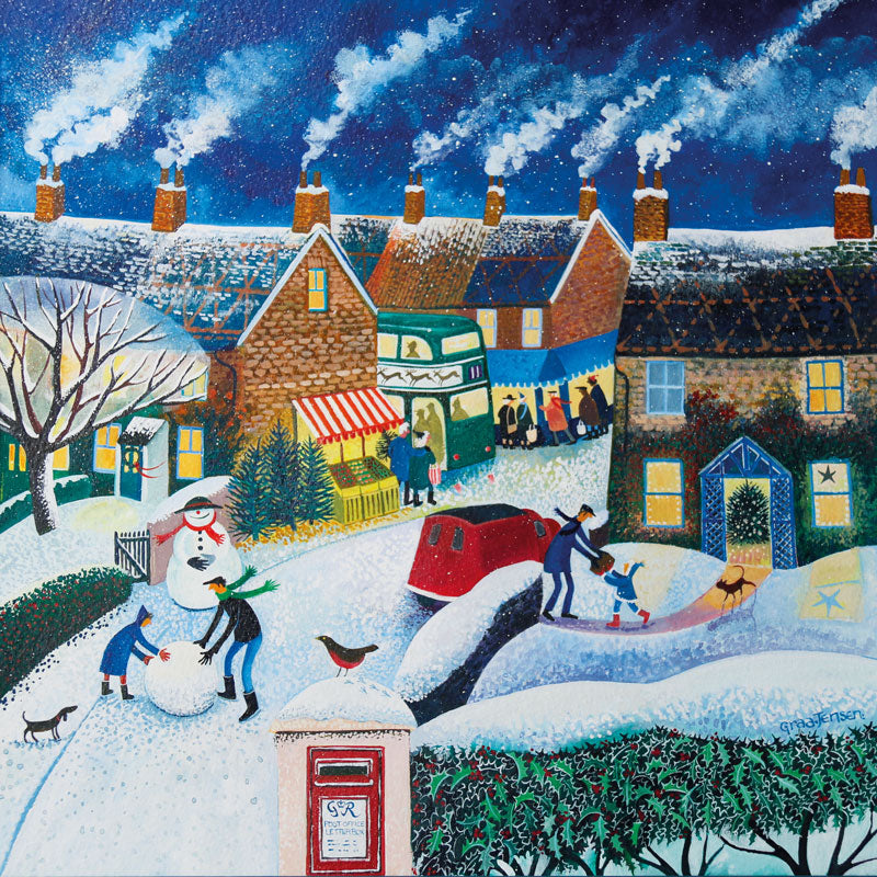Art greeting card by Lisa Graa Jensen. Christmas card. A snowy village scene, with people making a snowman, a letterbox, a post van and a Christmas bus. dark blue sky with smoke coming out of the chimneys.