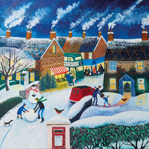 Art greeting card by Lisa Graa Jensen. Christmas card. A snowy village scene, with people making a snowman, a letterbox, a post van and a Christmas bus. dark blue sky with smoke coming out of the chimneys.