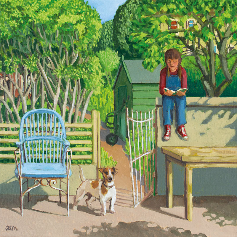 Young girl sitting on a wall reading a book with a Jack Russell dog beneath her. Green trees behind them.