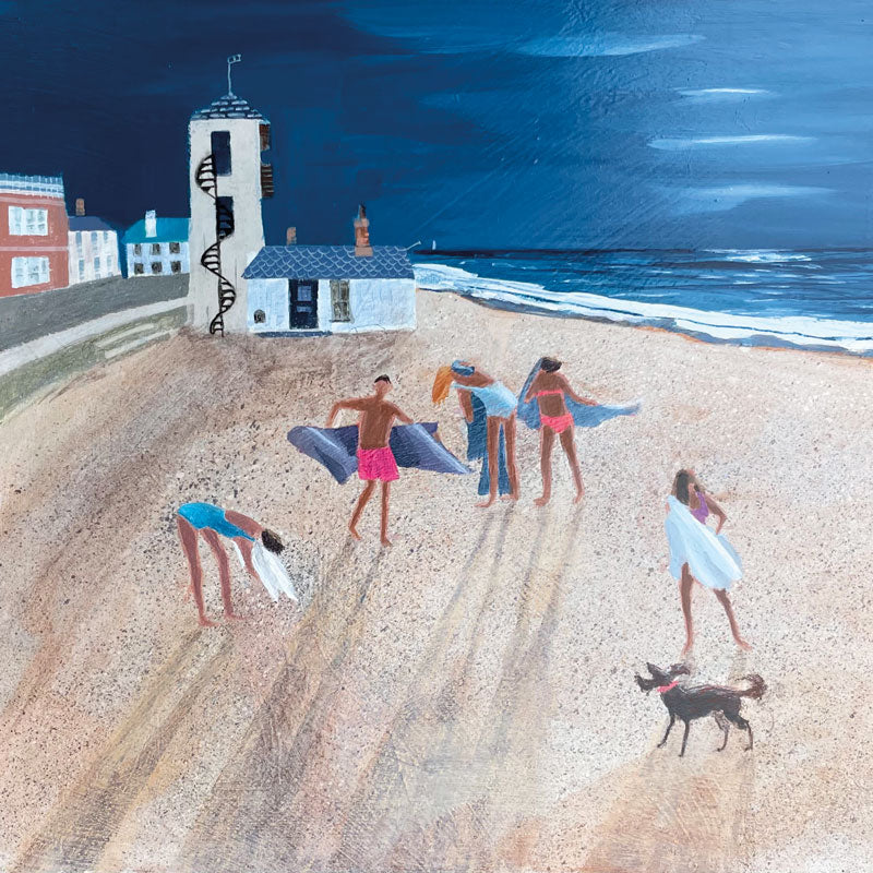 Group of sea swimmers drying themselves on a beach at moonlight. The Watchtower in the background.