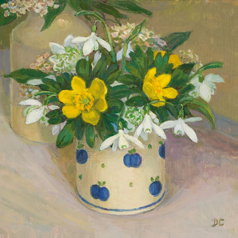 Ceramic vase with white snowdrops and yellow aconite flowers.